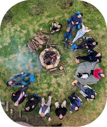 Group of friends gathered around a campfire
