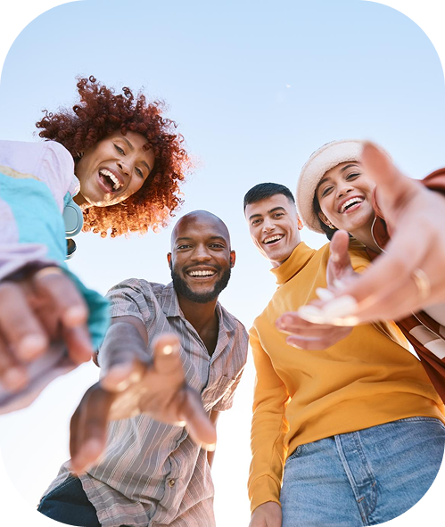Group of diverse friends reaching toward camera
